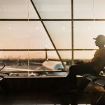 man sitting on gang chair near window