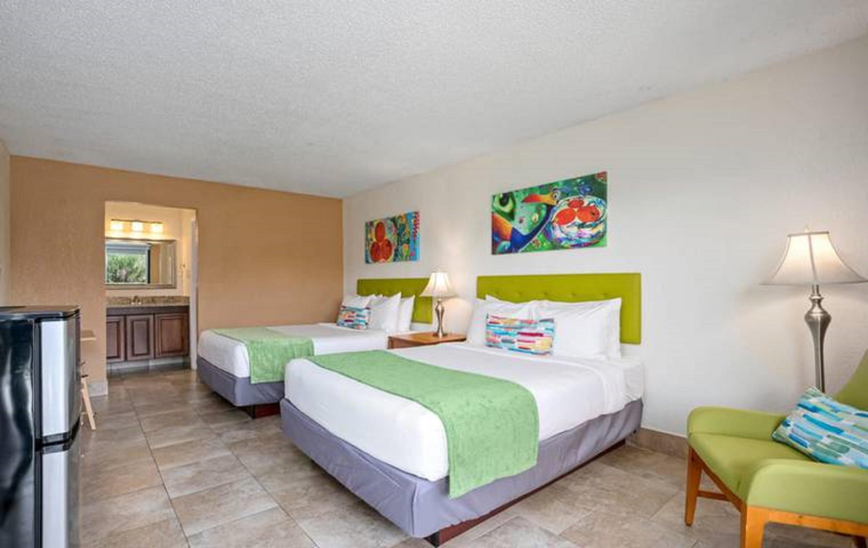 Family comparing hotel room layout and sleeping arrangements before booking