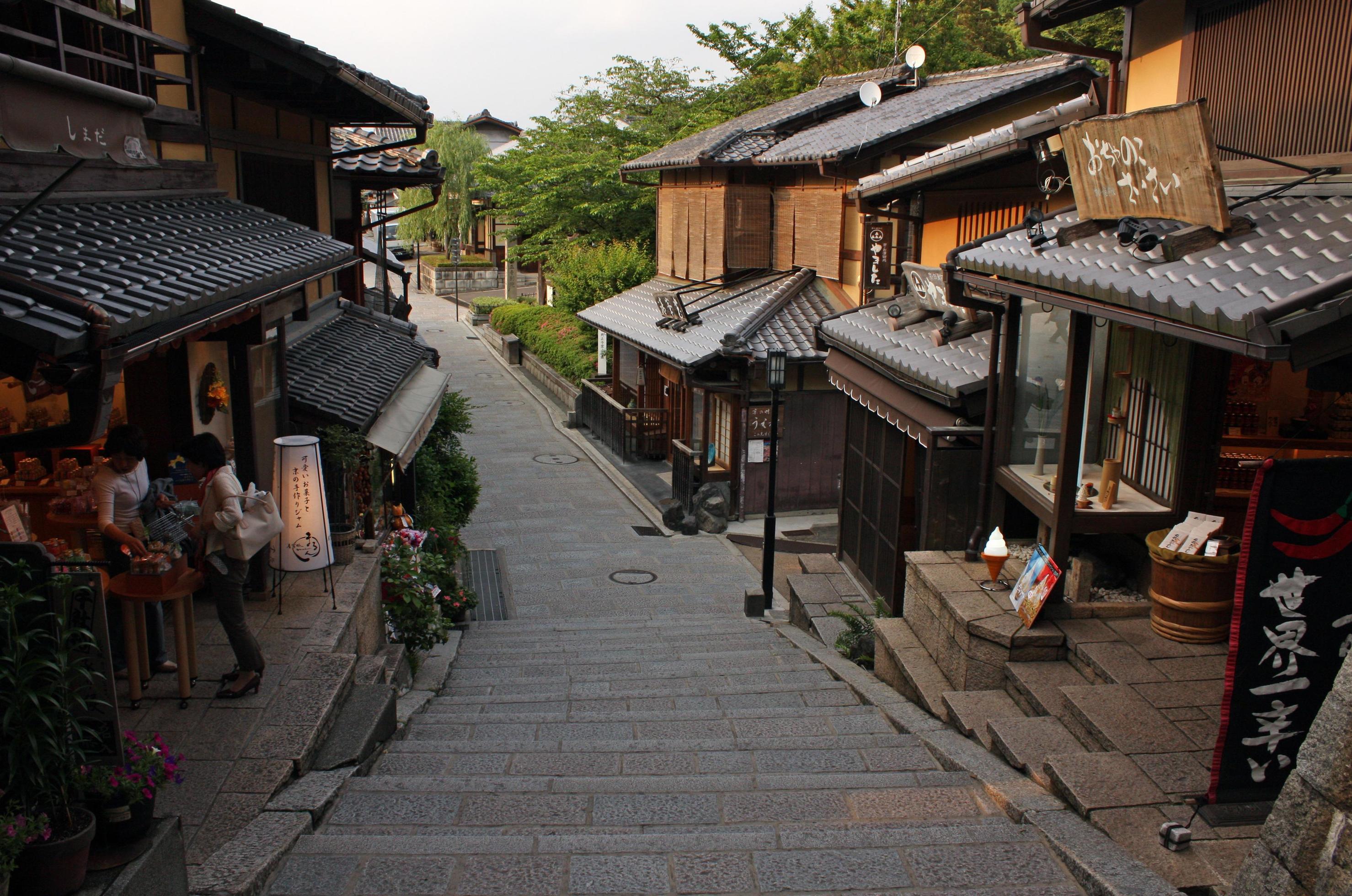 Travelers walking through a traditional Kyoto street