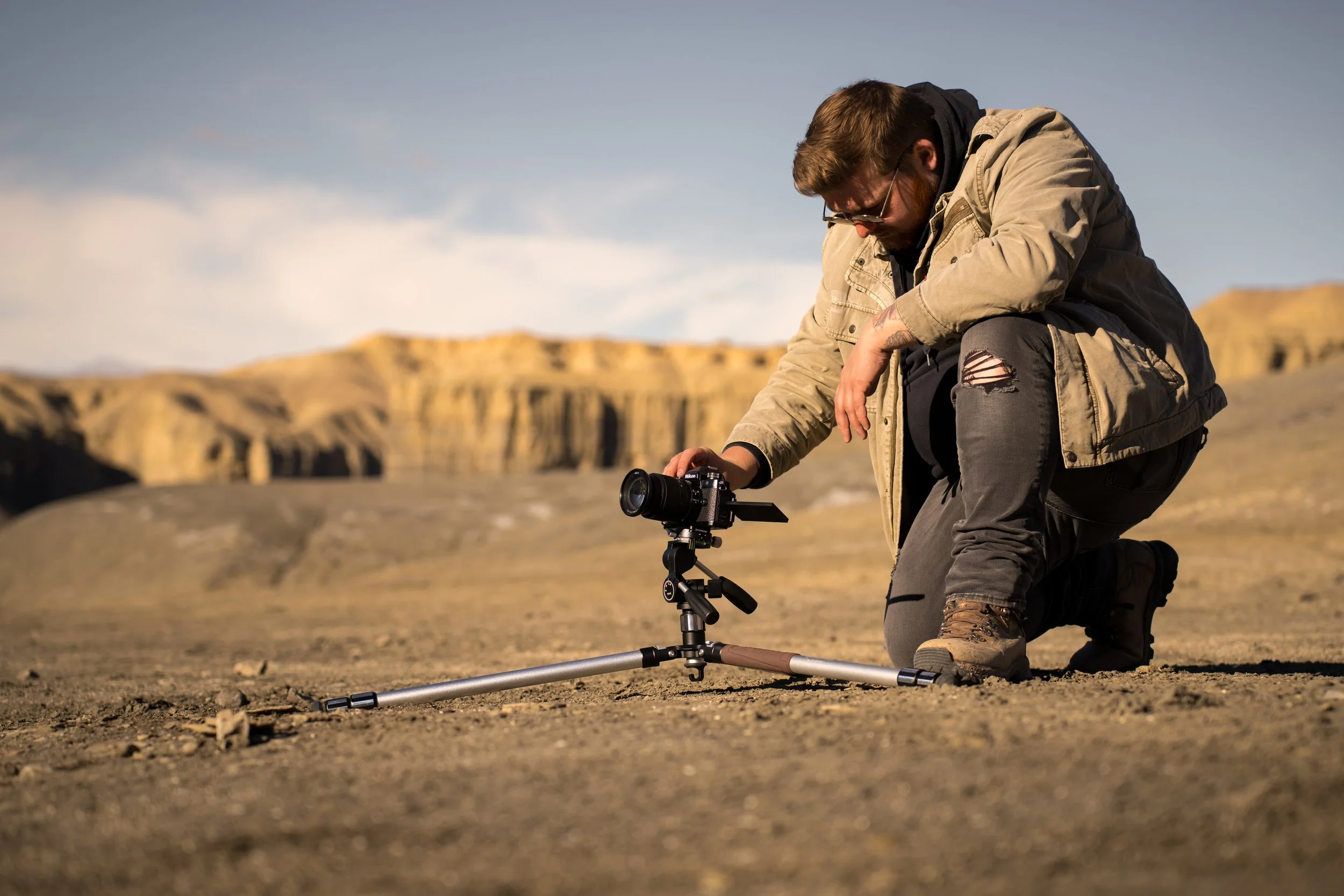 Landscape photographer using an established viewpoint without damaging the environment