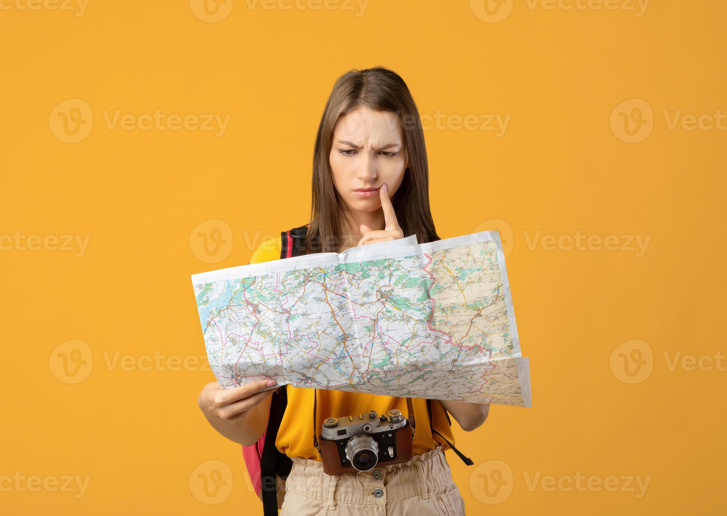 Traveler evaluating a hotel neighborhood using a city and transit map
